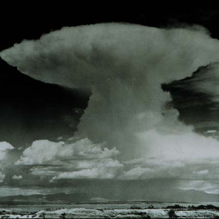 A tall cloud tower spreads into a broad, flattened anvil top.